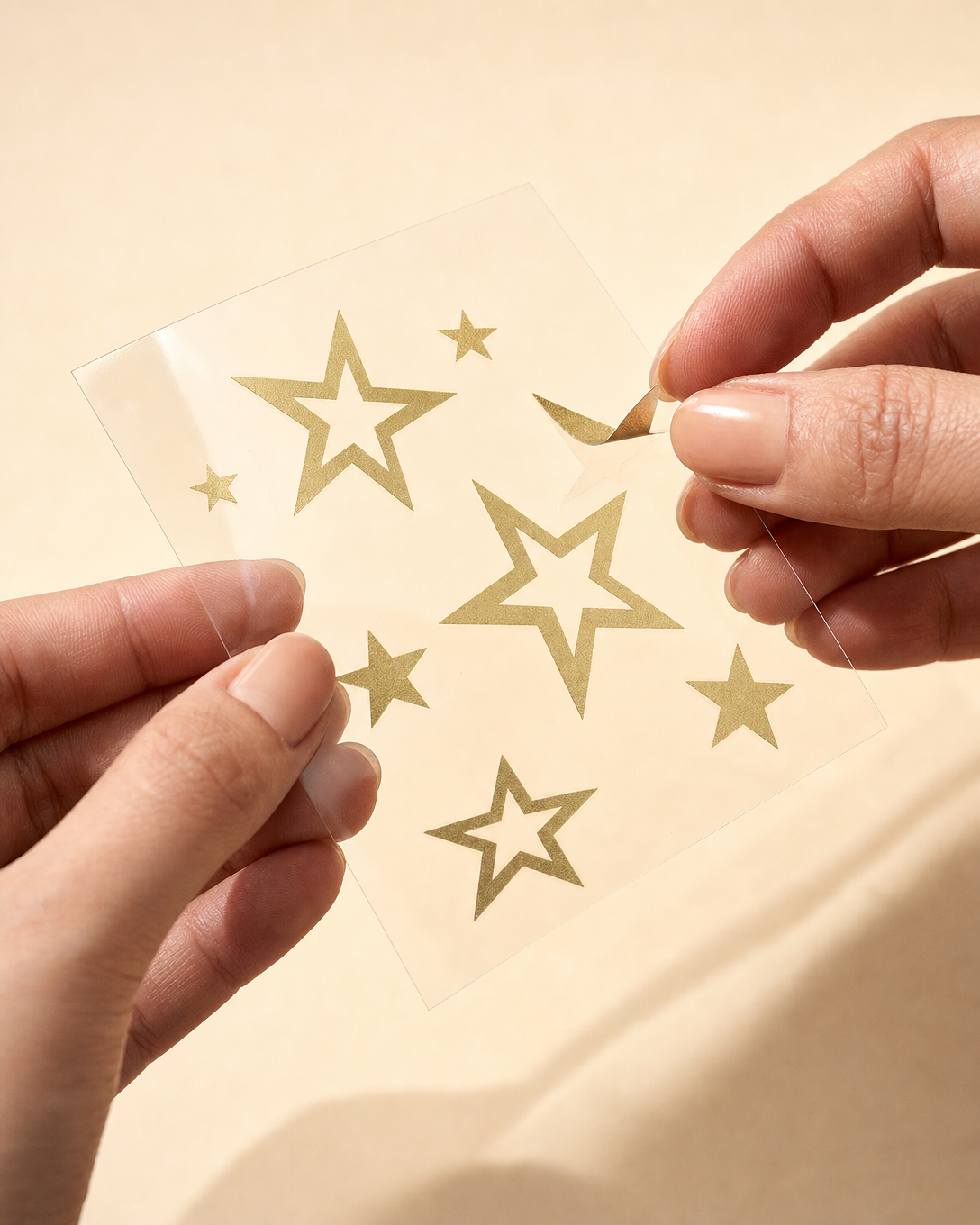 Peeling a gold star from the adhesive backing