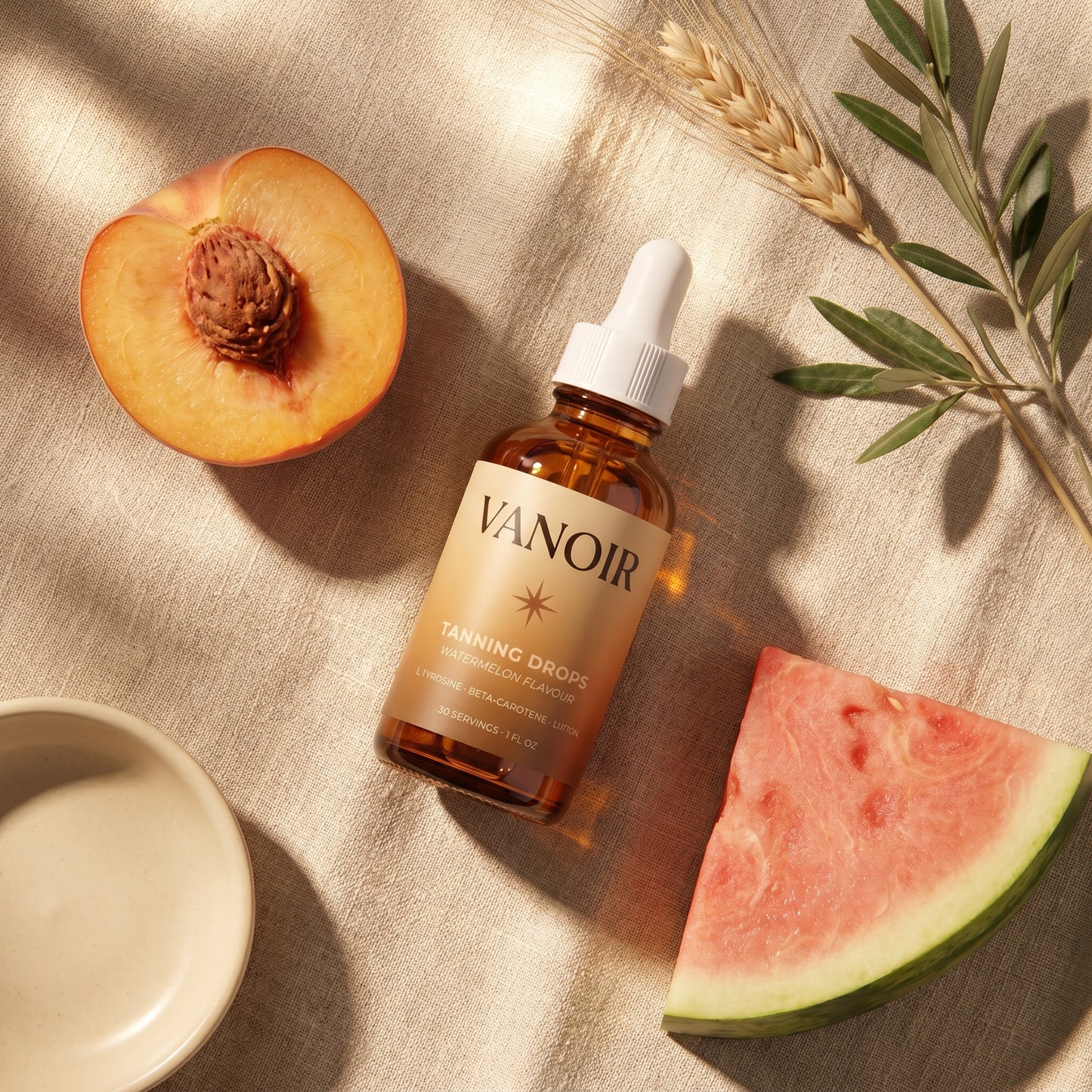 Mediterranean late-summer flat-lay with bottle, peach, watermelon