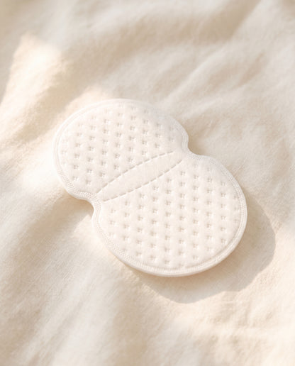 Single sweat pad on cream linen — honeycomb texture