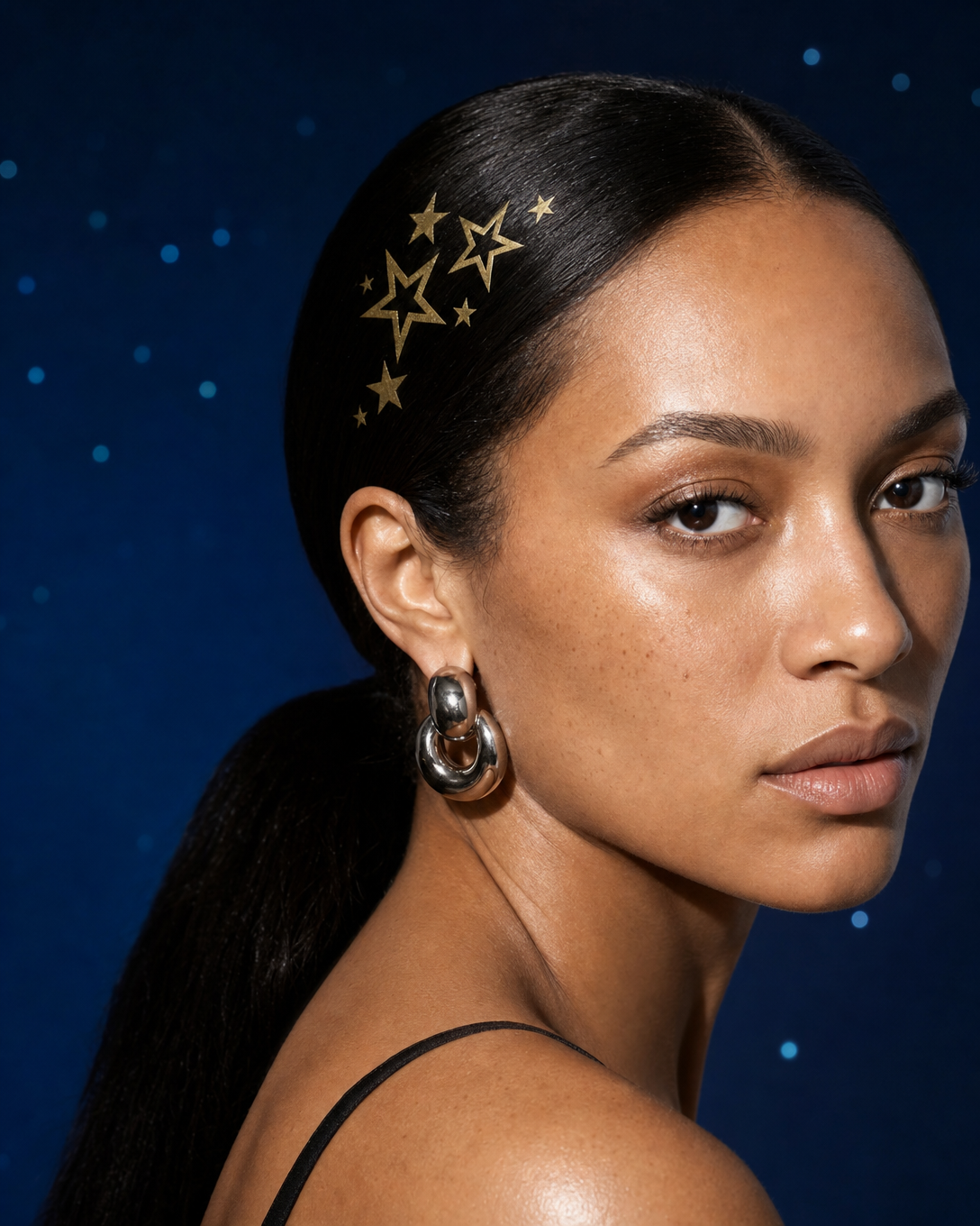 Vanoir Starstruck hero — gold star hair patches on slicked-back hair against starry night backdrop