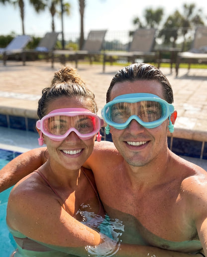 Adult couple in pool wearing Bubblegum and Reef goggles