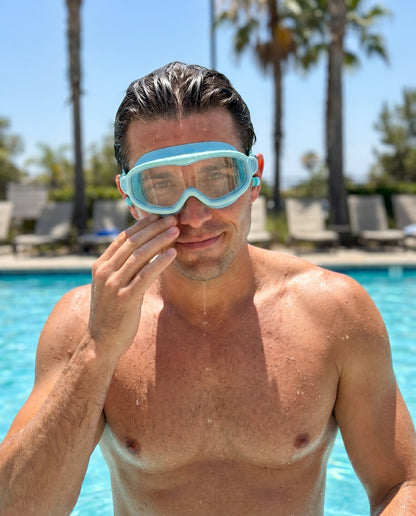 Adult man in pool wearing Reef goggles