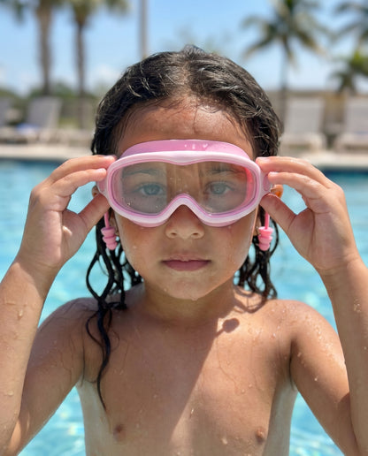 Girl in pool wearing Bubblegum goggles over her eyes