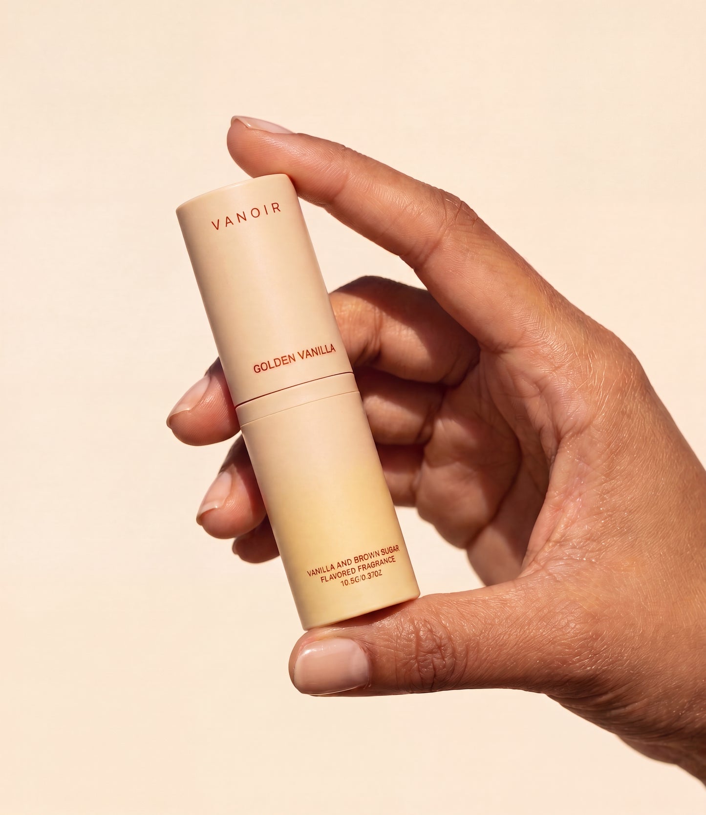 Chapstick-sized fragrance stick held in hand