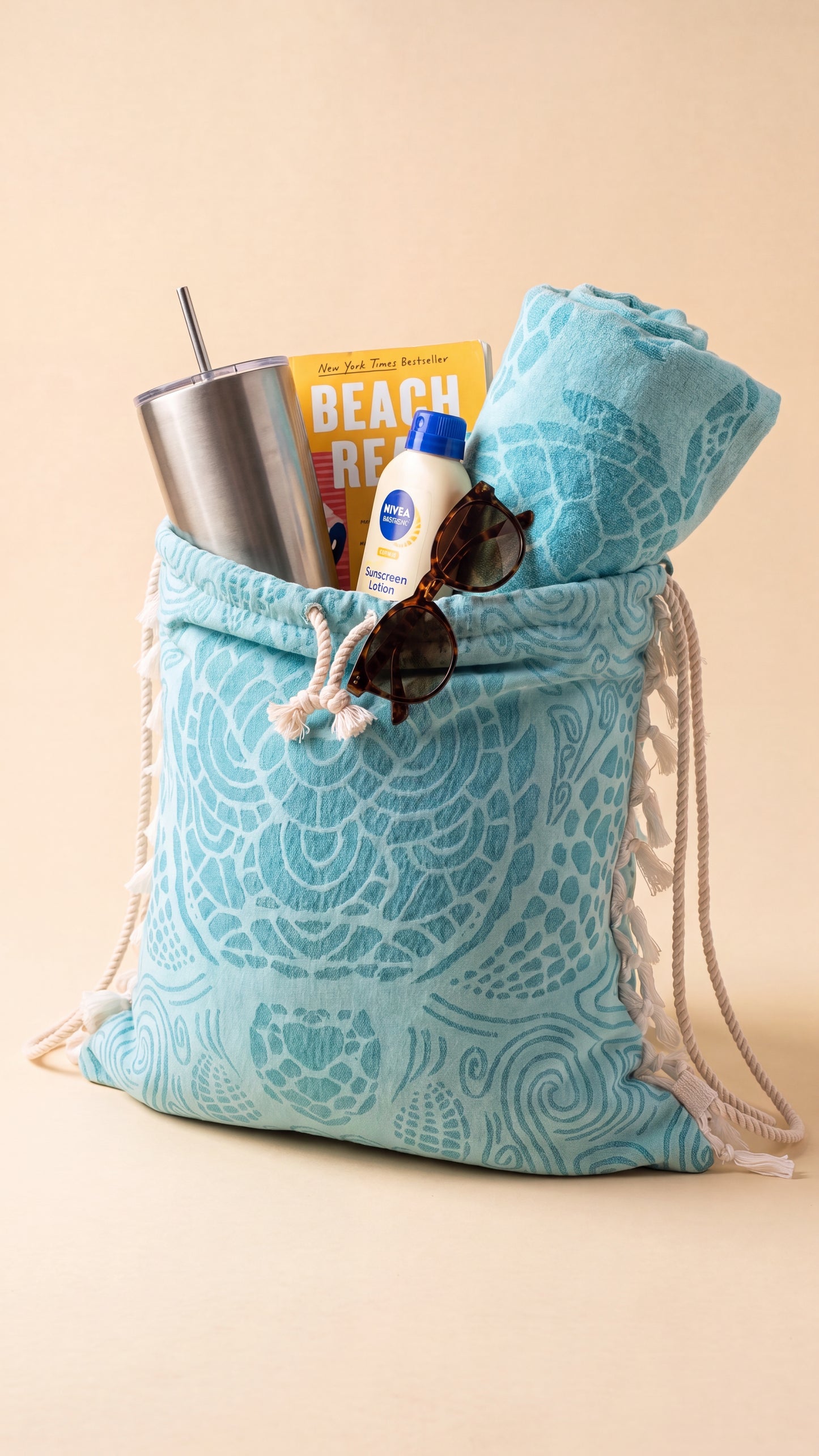 Holds everything — tumbler, book, sunscreen, sunglasses
